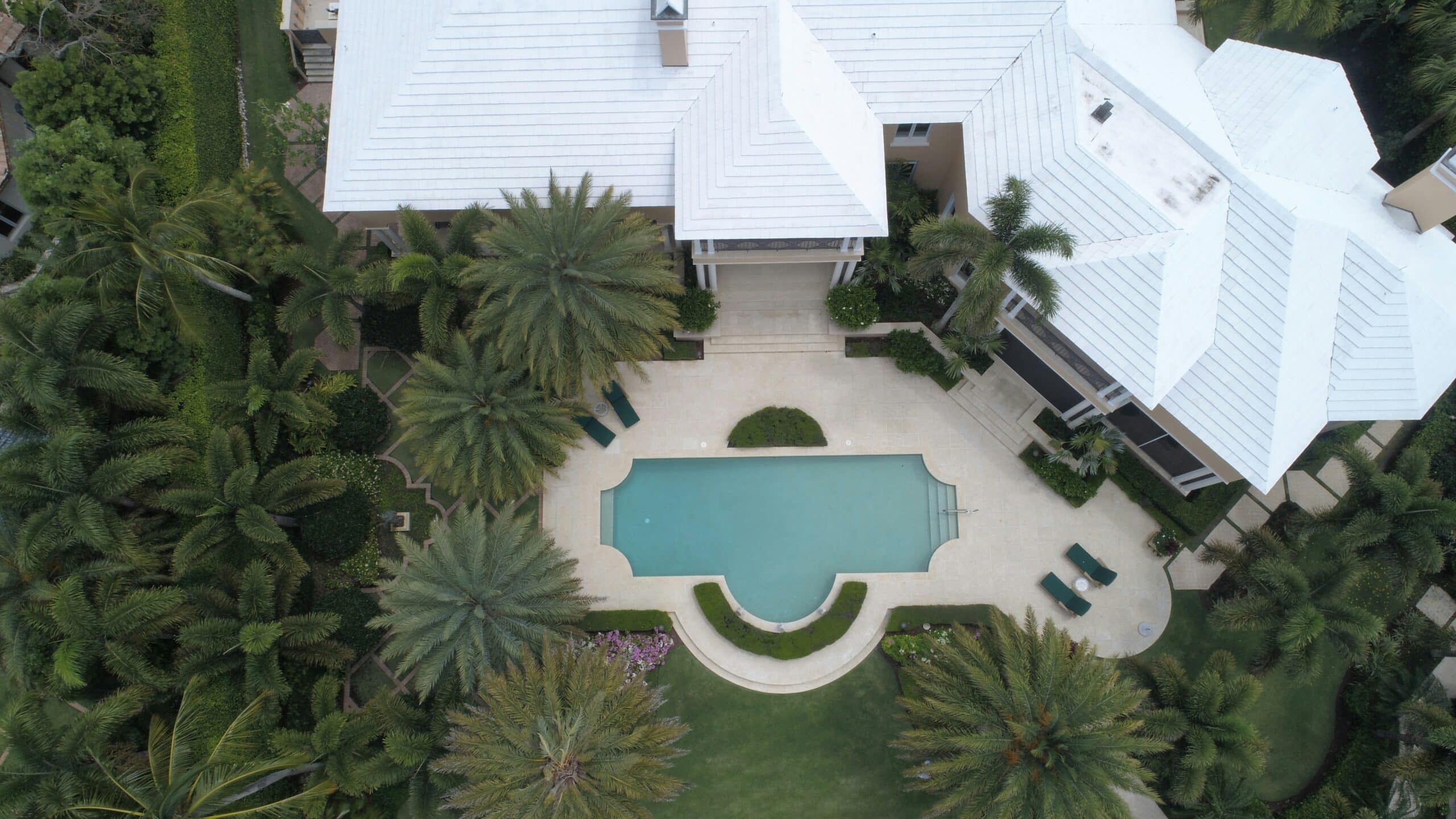 Drone top down view of a home with a pool and patio.