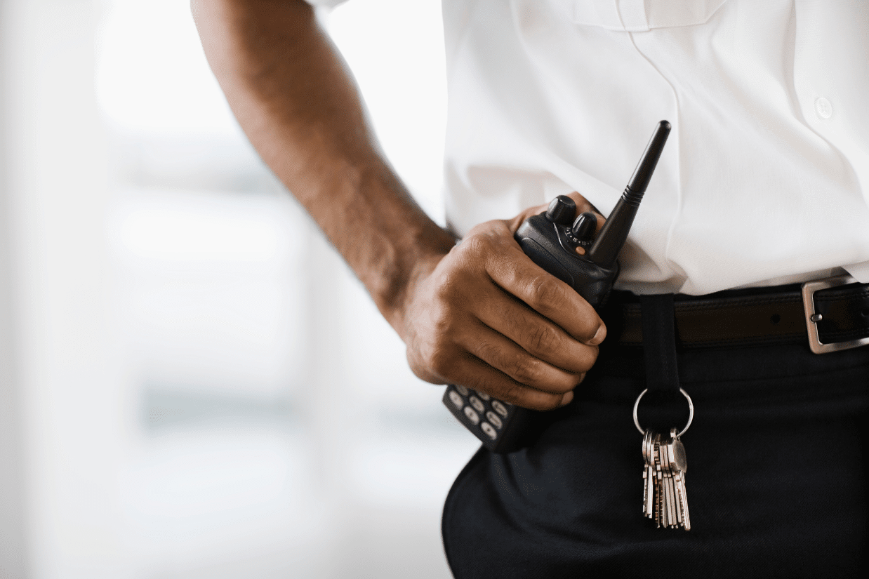 private-security-heartland Security guard holding walkie talkie